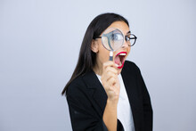 Beautiful Business Woman Looking Through A Magnifying Glass