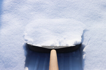 Shovel removes snow after snowfall in winter