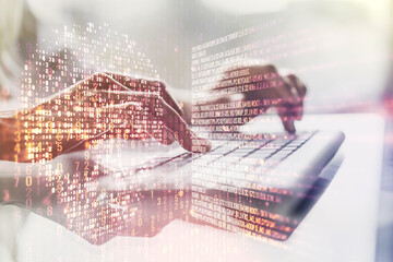 Double exposure of creative code skull hologram and hands typing on laptop on background. Malware and cyber crime concept