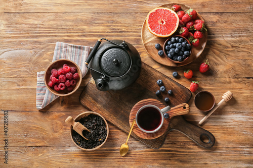 Composition with cup of hot fruit tea on wooden background © Pixel-Shot