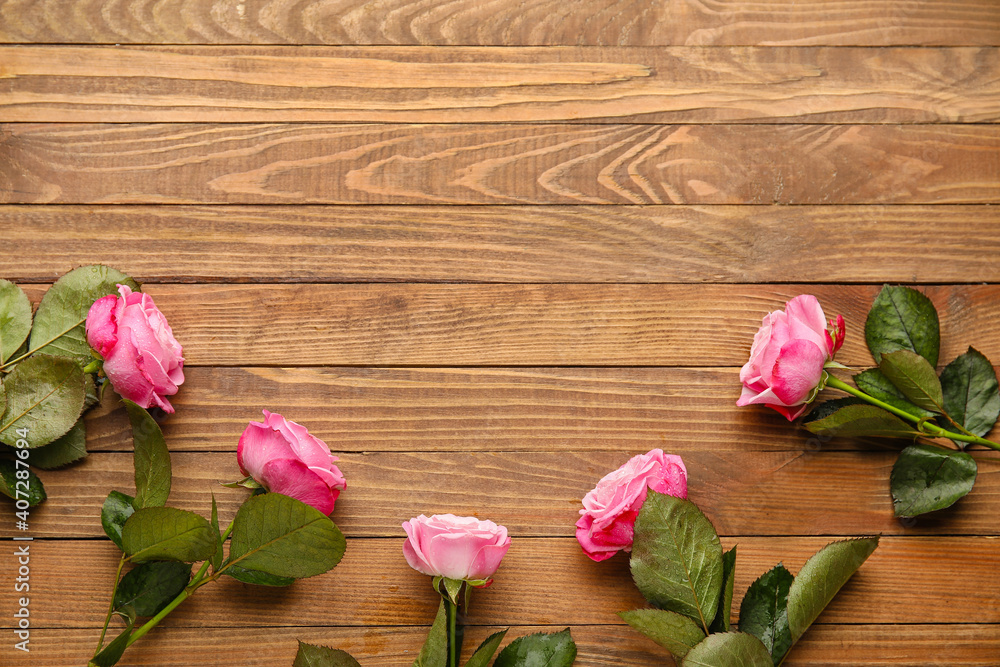 Beautiful pink roses on wooden background