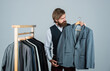 Shopper hipster man in fitting room menswear store, his size concept