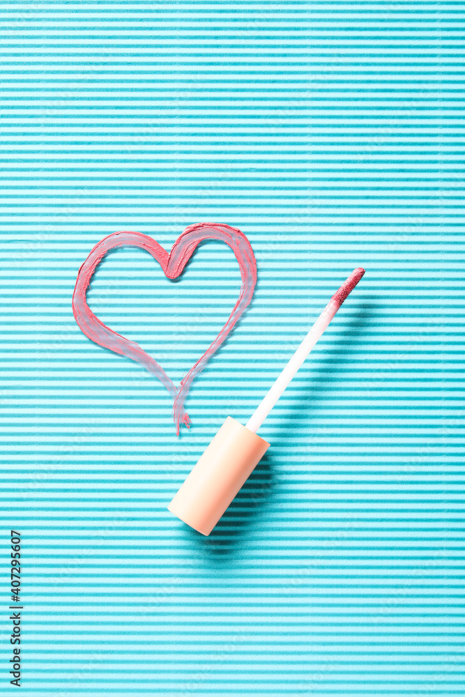 Heart drawn with lipstick on color background