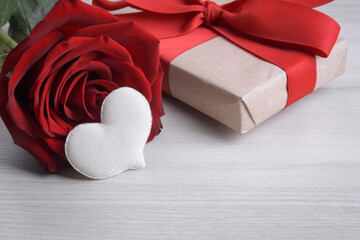 Background for Valentine's Day greeting card.Valentines day concept.Red gift ribbons, gifts, hearts on a wooden background.