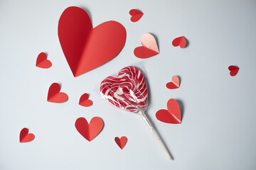 Wall Mural - Valentine's Day background. red hearts and lollipop on white background. Valentines day concept. Flat lay, top view, copy space