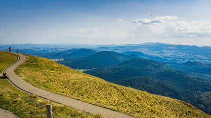 path and view on the Chaine des Puys volcanoes range from the top of the Puy de Dome, the most famous volcano this range, in Auvergne, France