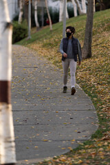 Wall Mural - woman is  doing sports with virus mask in pandemic days in the park