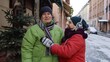 © Andrii Iemelianenko - Senior couple grandmother and grandfather tourists in colorful winter jackets walking, talking, gesturing on city street in town Lviv, Ukraine. Elderly family man, woman on holidays vacation traveling