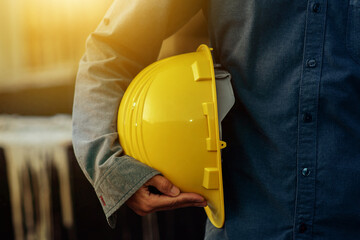 Close up Engineer holding hard hat on site construction