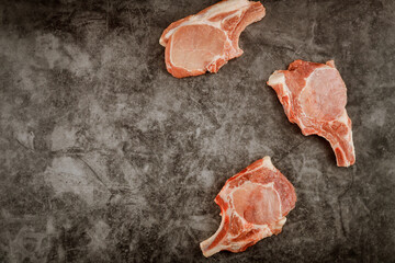 Wall Mural - Sliced raw pork chops rib on gray background.