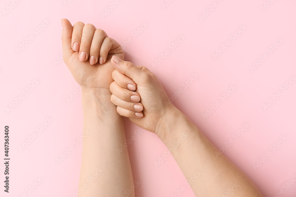 Hands with beautiful manicure on color background
