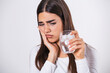 © Graphicroyalty - Young woman with sensitive teeth and hand holding glass of cold water with ice. Healthcare concept. woman drinking cold drink, glass full of ice cubes and feels toothache, pain