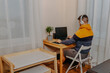 © Маргарита Щипкова - Young man playing computer games in white headphones. Gamer at home. Man working on computer at home.