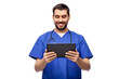 © Syda Productions - medicine, healthcare and technology concept - happy smiling doctor or male nurse in blue uniform with stethoscope using tablet pc computer over white background