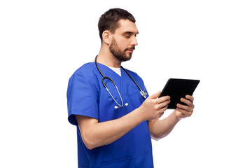 medicine, healthcare and technology concept - doctor or male nurse in blue uniform with stethoscope using tablet pc computer over white background