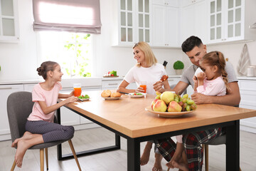 Sticker - Happy family having breakfast together at table in modern kitchen