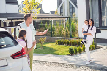 Wall Mural - Photo portrait of big family meeting after school and work waving hands saying hi outdoors on street in summer