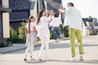 © deagreez - Back side photo of nice funny family hold boy up walk near home wear casual cloth outside