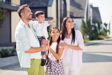 Wall Mural - Photo of sweet funny family boy pointing walk near home wear casual cloth outside