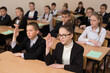 © Artem Zakharov - Happy schoolchildren sit at a desk in the classroom