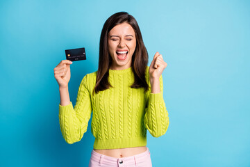 Poster - Photo portrait of screaming girl holding plastic card in one hand isolated on pastel blue colored background