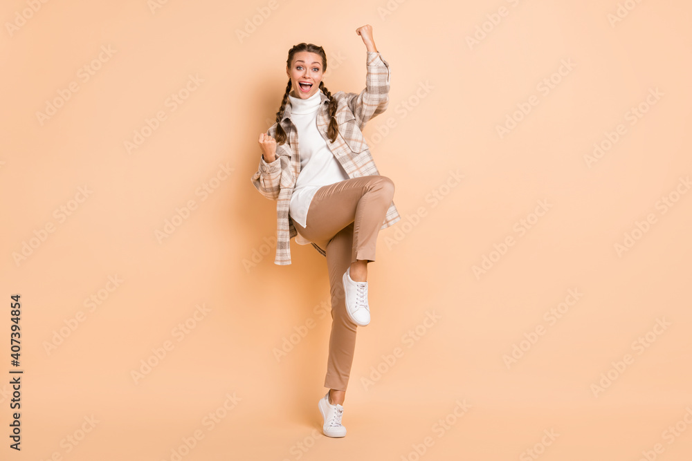 Full size photo of hooray nice girl hands fists wear white shirt trousers sneakers isolated on beige color background - obrazy, fototapety, plakaty 