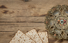 Jewish Passover Holiday. Matzot And Vintage Traditional Pesah Plate With Text In Hebrew: Passover, Horseradish, Celery, Egg, Bone, Maror, Charoset.