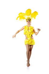 Wall Mural - Professional. Beautiful young woman in carnival, stylish masquerade costume with feathers dancing on white studio background. Concept of holidays celebration, festive time, dance, party, having fun.