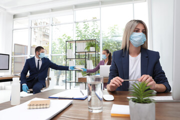 Wall Mural - Office employees in respiratory masks at workplace