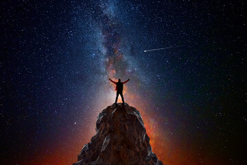 Wall Mural - man on top of a mountain observing the universe