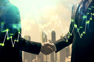 Double exposure of forex graph hologram and handshake of two men. Stock market concept.