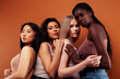 © iordani - young pretty asian, caucasian, afro woman posing cheerful together on brown background, lifestyle diverse nationality people concept