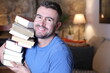 © ajr_images - Man holding heavy pile of books