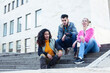 © iordani - cute group of teenages at the building of university with books huggings, diversity nations real students lifestyle