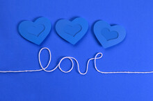 Three Blue Hearts Over The Word "love"