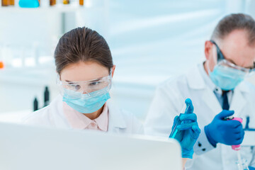 Wall Mural - close up. female scientist with a test tube in her hands.