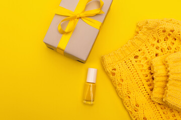 Canvas Print - top view of nail polish near wrapped present and jumper isolated on yellow