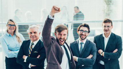 Wall Mural - very happy businessman standing in front of his business team