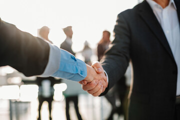 close up. strong handshake of business people on the office background