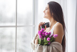 Fototapeta Tulipany - Closeup portrait og young very beautiful brunette woman with flowers