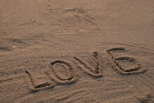 Handwritten Love Words On The Beach Sand