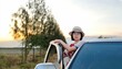 © Rung Kh - Woman girl standing in car park of travel holiday weekend.