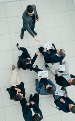 Wall Mural - top view. Manager asks questions during a business meeting.