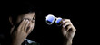 © anut21ng Stock - Asian Man rubbing tired eyes. Problem with glasses, eyesight or vision Working with computer at night