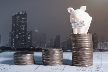 Wall Mural - Coins with piggy bank. Save money Concept for business, education and financial investment, Double exposure of city night and stack of coins for finance investor, ECN Digital economy, business, money,