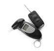 Modern breathalyzer and car key on white background, top view