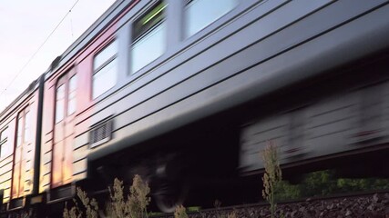 Wall Mural -  Passenger train fast running to the sunset