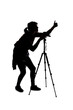 Silhouette of a photographer with a camera on a white background isolated for composites. She is posed with a thumbs up gesture