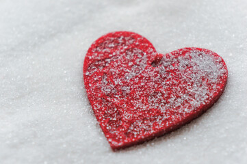 a red heart on a sugar background