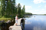 Fototapeta  - Frau an einem See in Schweden